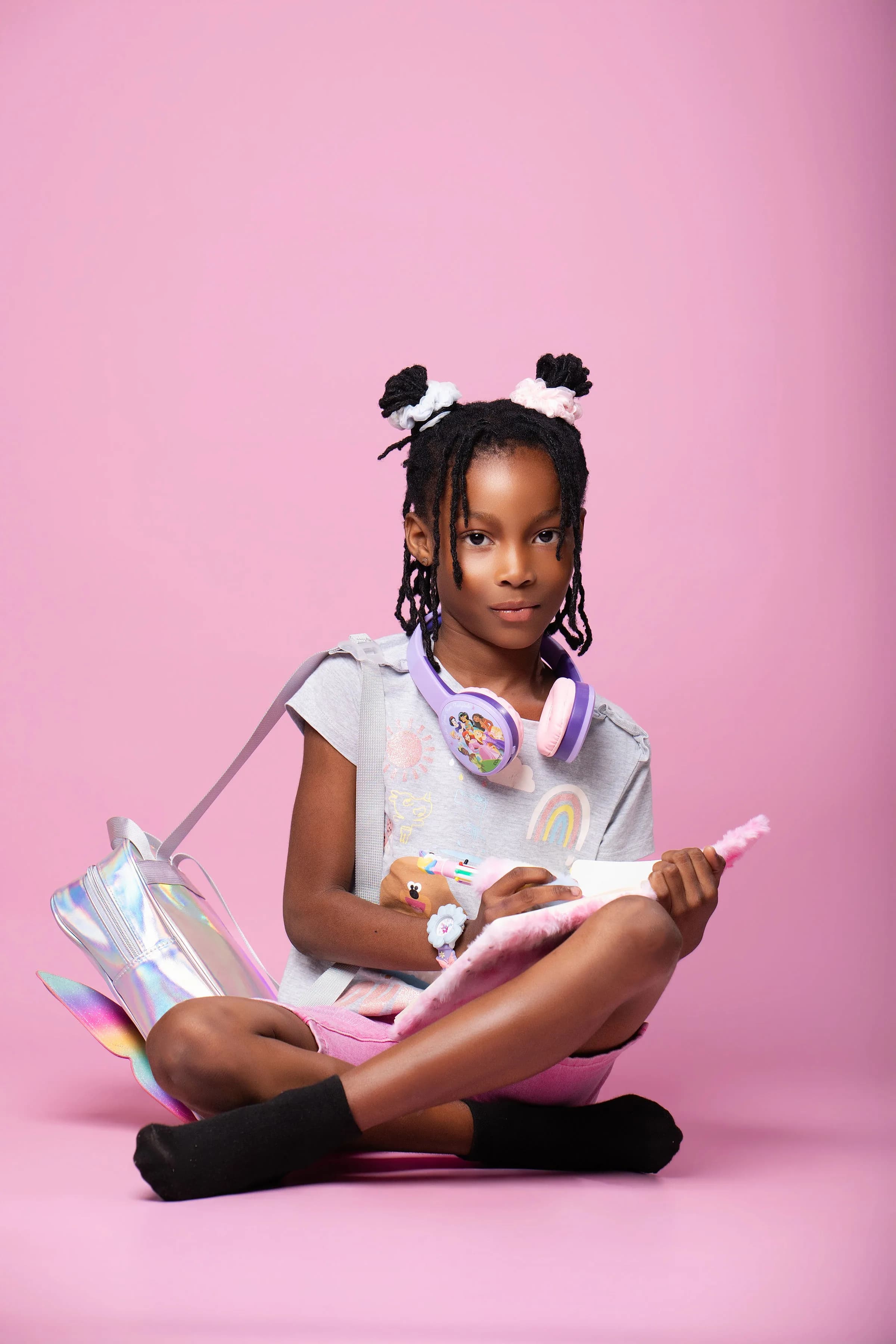 Two children resting with headphones and accessories